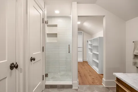a bathroom with a tub shower and couch