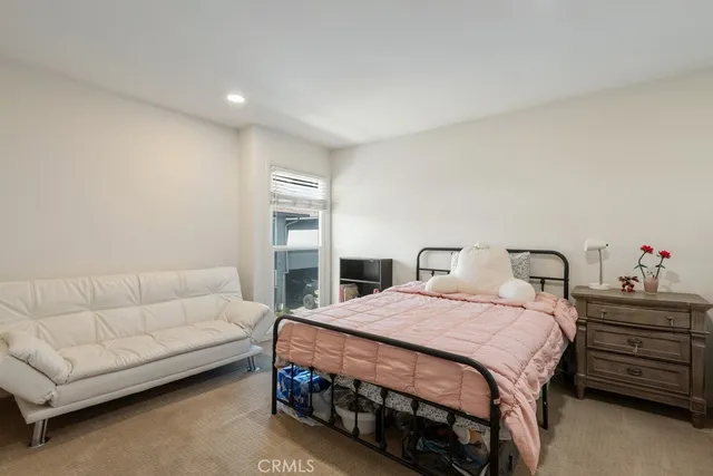 a bedroom with a bed and a couch