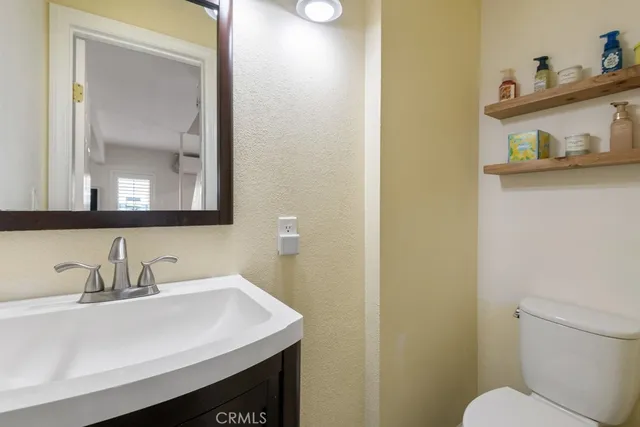 a bathroom with a sink a mirror and a toilet