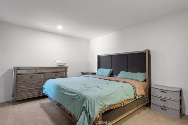 a bedroom with a bed and a dresser