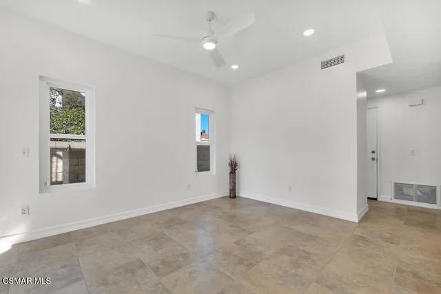 an empty room with windows and closet