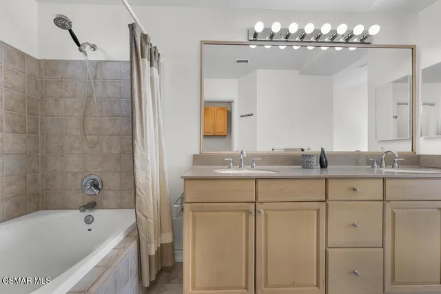 a bathroom with a granite countertop sink a toilet and bathtub