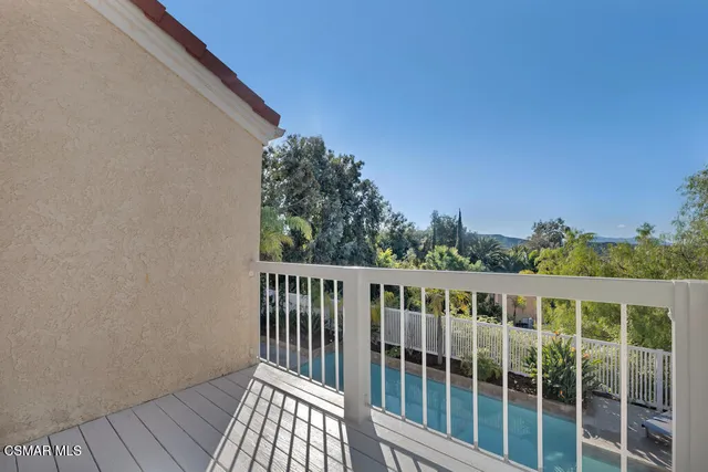 a balcony with wooden floor and fence