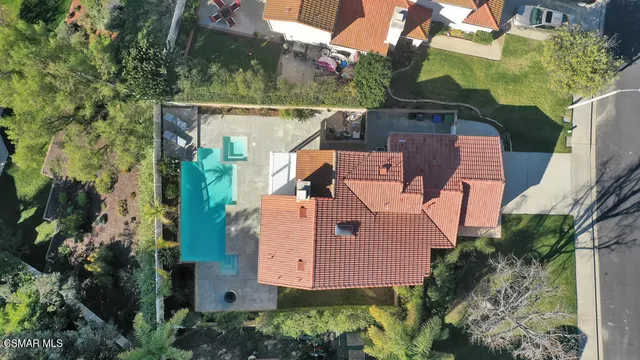 an aerial view of lake and residential houses with outdoor space