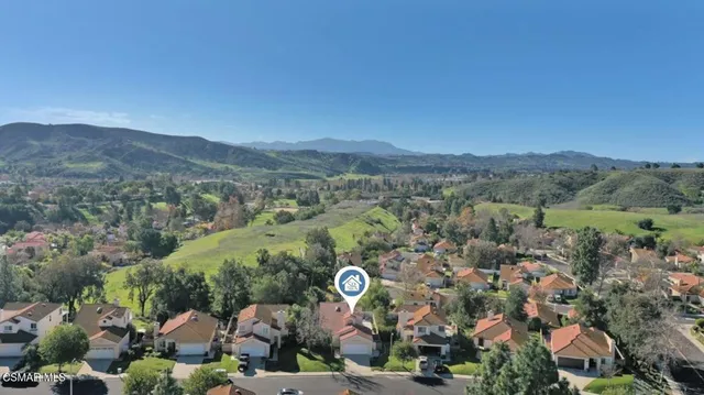an aerial view of a house with garden space and street view
