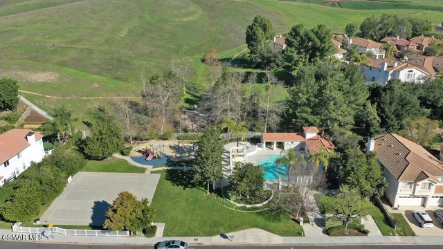 an aerial view of a house with a yard and trees