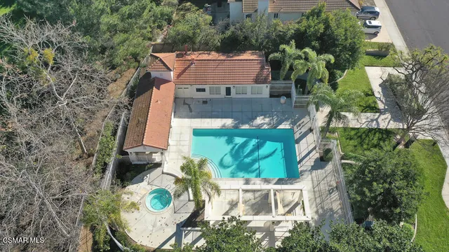 an aerial view of a house with yard swimming pool and outdoor seating