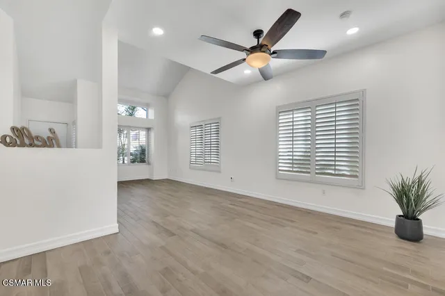 a view of a livingroom with a window and wooden floor