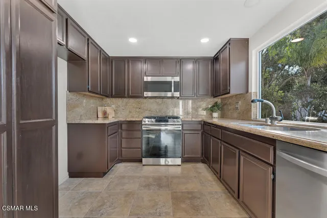a kitchen with a sink stove and refrigerator