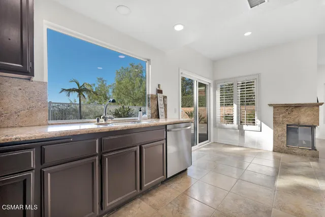 a kitchen with a sink and large window