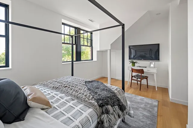 a bedroom that has a bed and a window in it