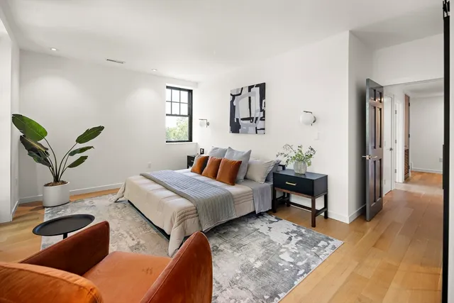 a bedroom with furniture and a wooden floor