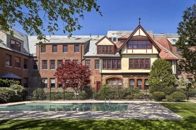 a front view of a residential apartment building with a yard