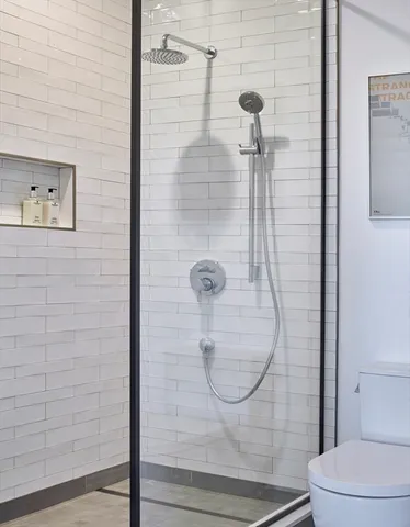 a bathroom with a glass shower door