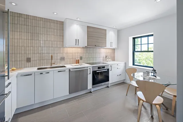 a kitchen that has a sink and a stove in it
