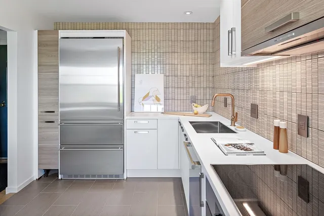 a kitchen with a refrigerator and a stove
