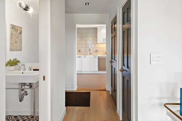 a bathroom with a tub shower and a sink