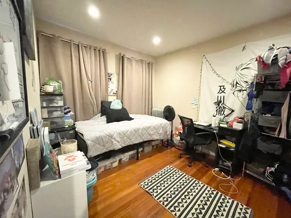 a bedroom with a bed a table and chair