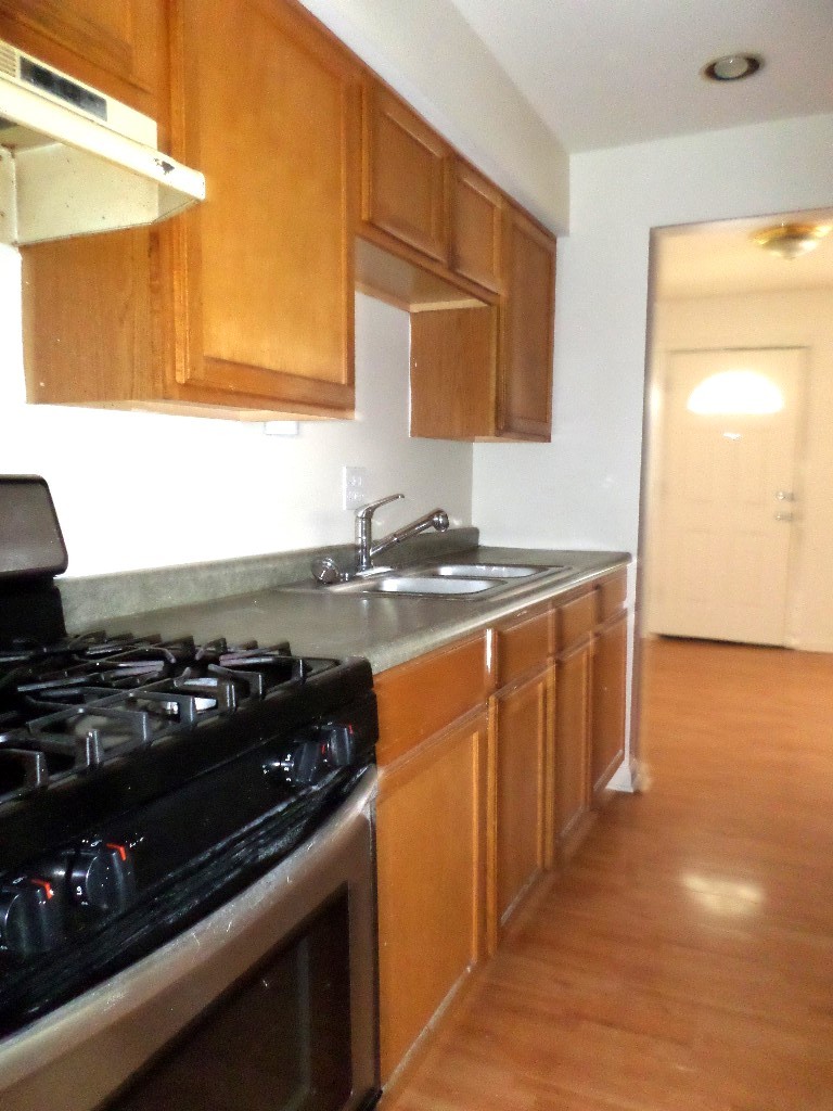 3546 147th Street, Unit 8 Midlothian, IL 60445 - Photo 2 of 8 a kitchen with a sink stove and microwave