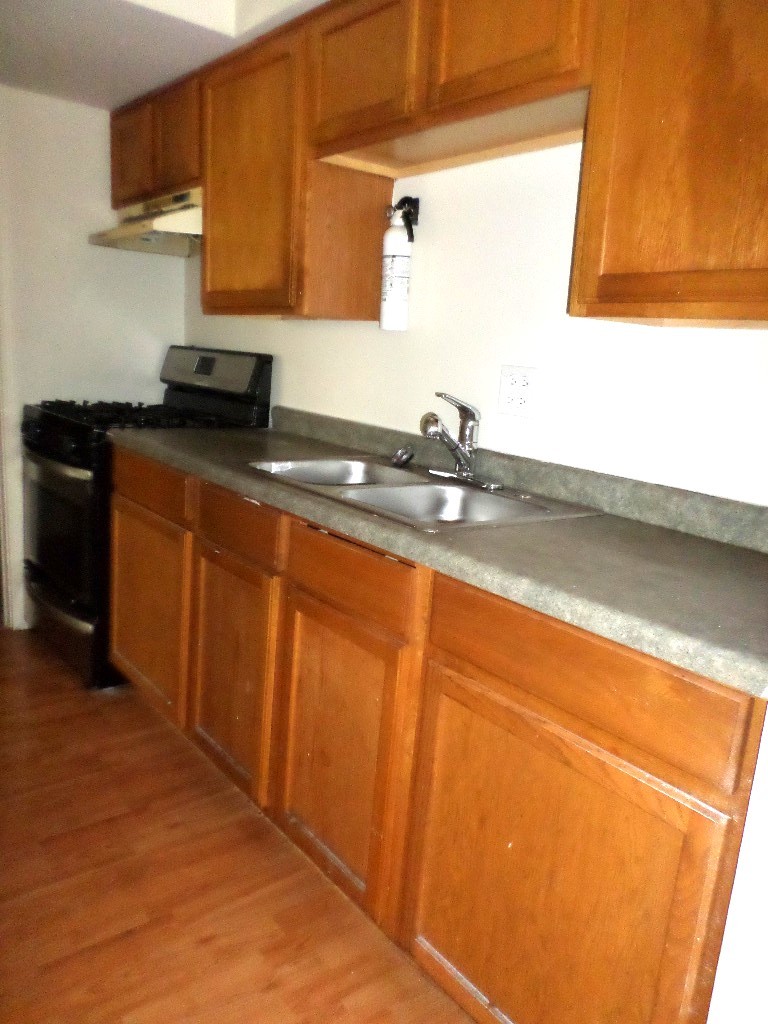 3546 147th Street, Unit 8 Midlothian, IL 60445 - Photo 3 of 8 a kitchen with granite countertop sink and cabinets