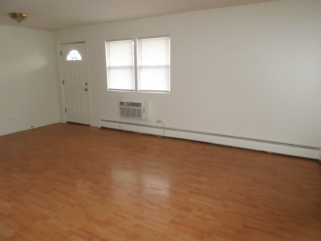 3546 147th Street, Unit 8 Midlothian, IL 60445 - Photo 5 of 8 an empty room with a empty space and windows