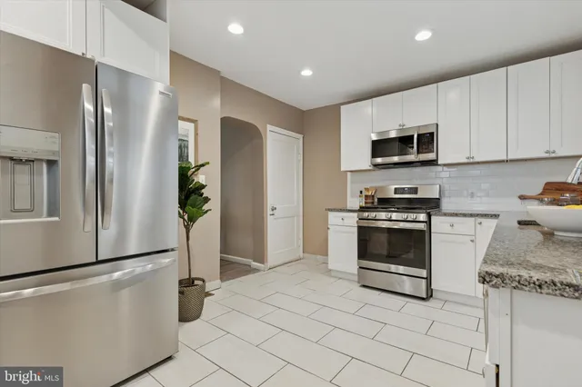 a kitchen with stainless steel appliances a refrigerator stove and microwave