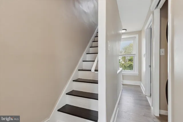 a view of entryway with stairs and wooden floor