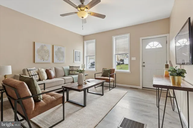 a living room with furniture and wooden floor