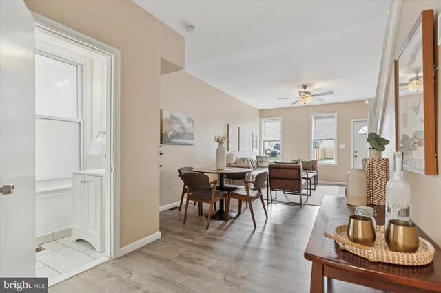 a living room with furniture a window and a dining table