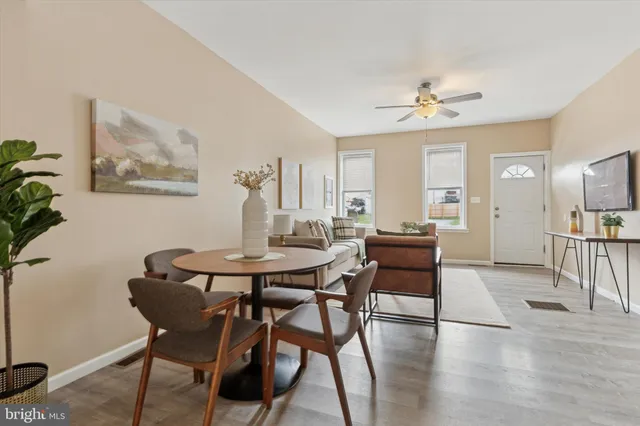a view of a dining room with furniture and wooden floor