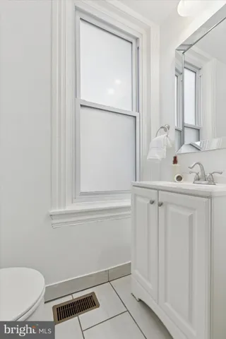 a bathroom with a sink toilet and vanity
