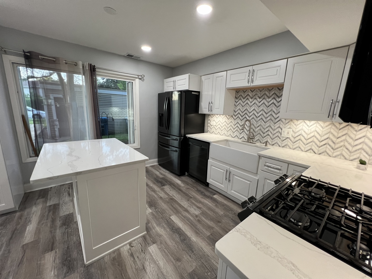 1067 Cascade Drive Aurora, IL 60506 - Photo 5 of 20 a kitchen with stainless steel appliances a stove a refrigerator a sink and white cabinets