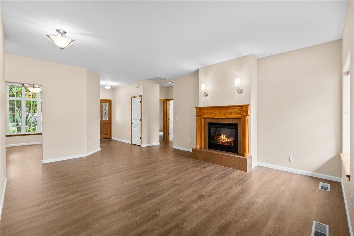 802 Ridgeway Avenue Central Point, OR 97502 - Photo 12 of 33 a view of an empty room with wooden floor fireplace and a window