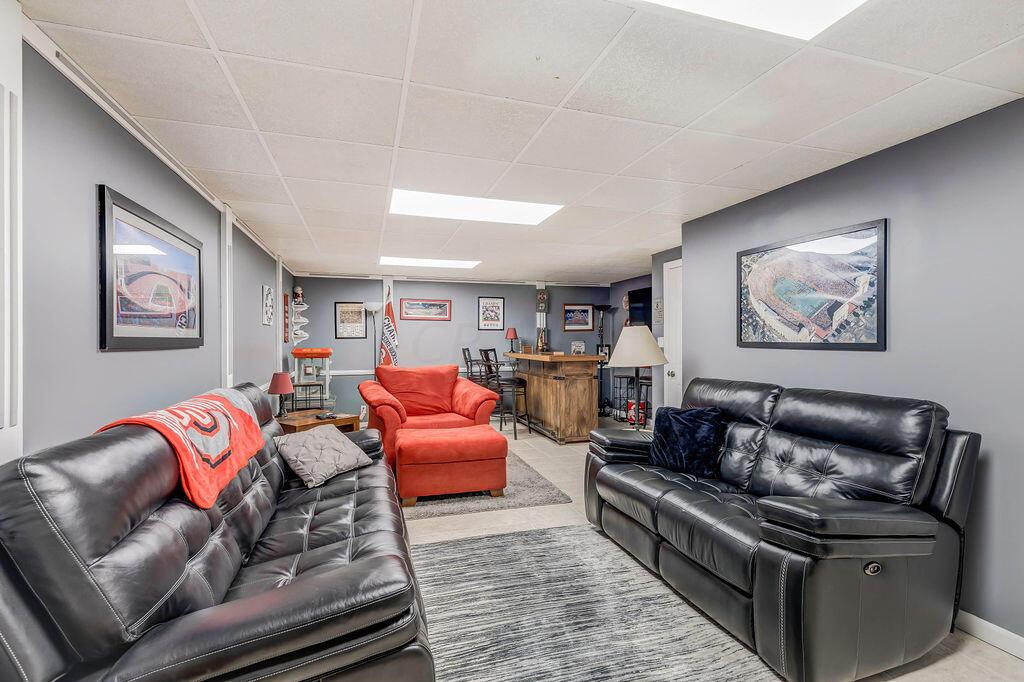 1300 Hubbard Road Galloway, OH 43119 - Photo 47 of 89 • Ceramic tile flooring • Grey painted walls • Acoustic ceiling tiles • Fluorescent lighting • Chair railing • Dry bar does not remain • TV is negotiable • Access to Mechanical Room