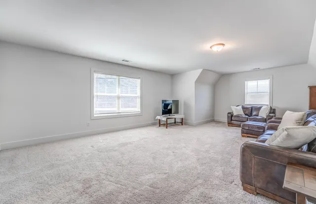 a living room with furniture and a chair