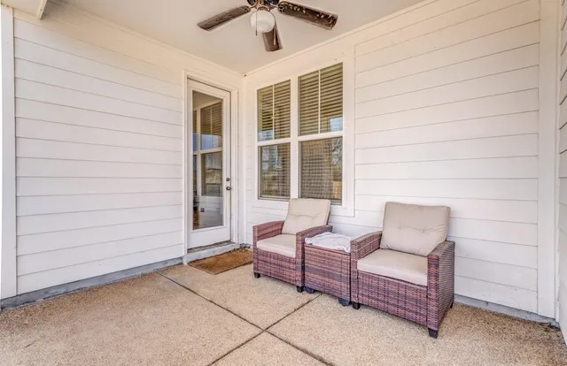 a view of a house with yard and sitting area
