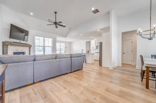 a living room with furniture and a wooden floor