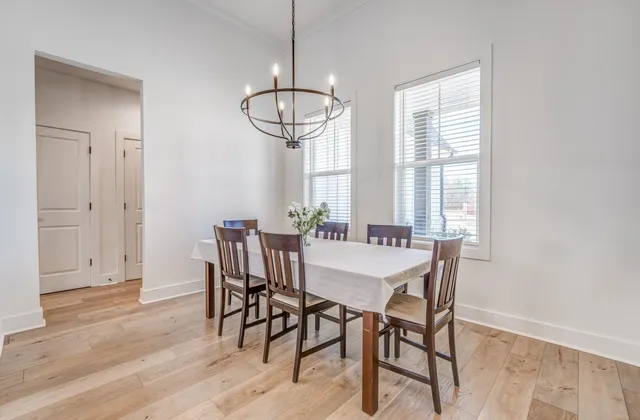 a view of a dining room with furniture wooden floor and chandelier