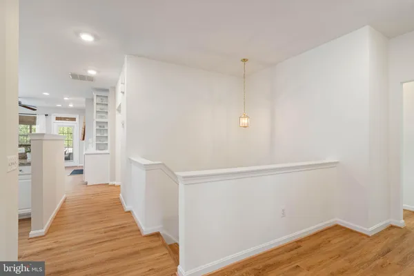 a view of a hallway with wooden floor