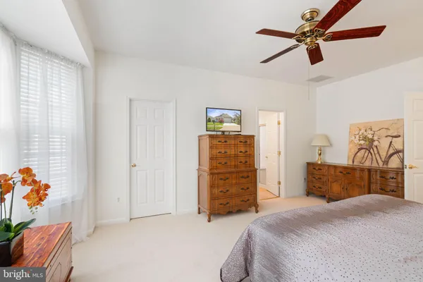 a bedroom with a bed dresser and a window