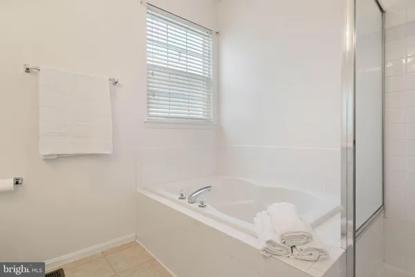 a white bath tub sitting next to a window