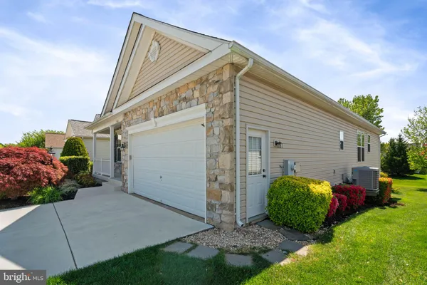 a view of a house with a backyard and a garage