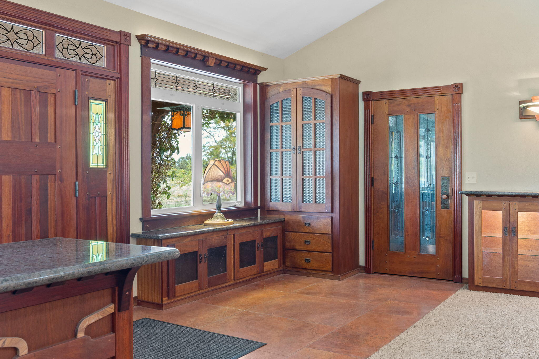 21925 Bear Creek Road Bend, OR 97702 - Photo 20 of 104 Entryway with Italian Stone floors, door to Garage and solid wood built-ins