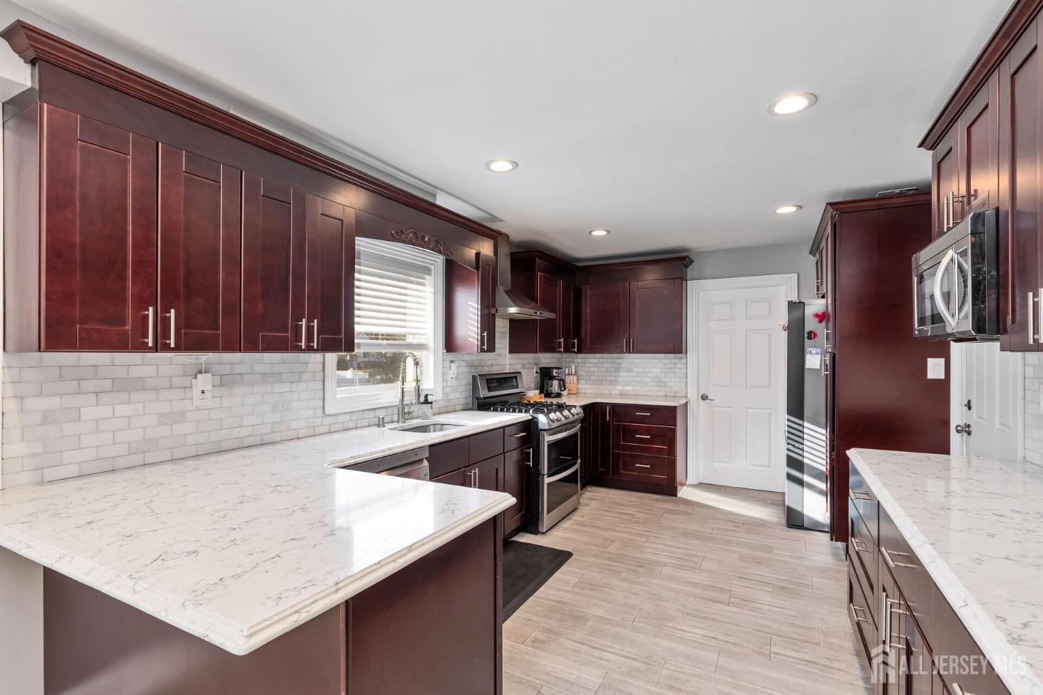 4 Indiana Road Somerset, NJ 08873 - Photo 11 of 31 a large kitchen with stainless steel appliances lots of counter space and a sink