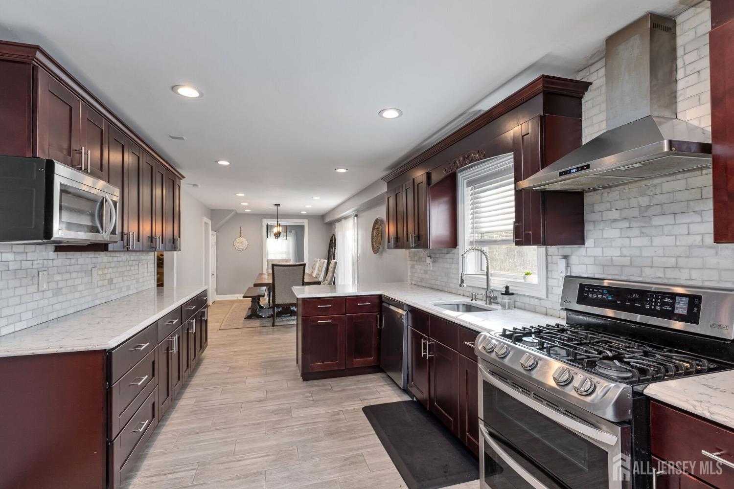4 Indiana Road Somerset, NJ 08873 - Photo 13 of 31 a large kitchen with stainless steel appliances granite countertop plenty wooden cabinets counter space a sink and a stove