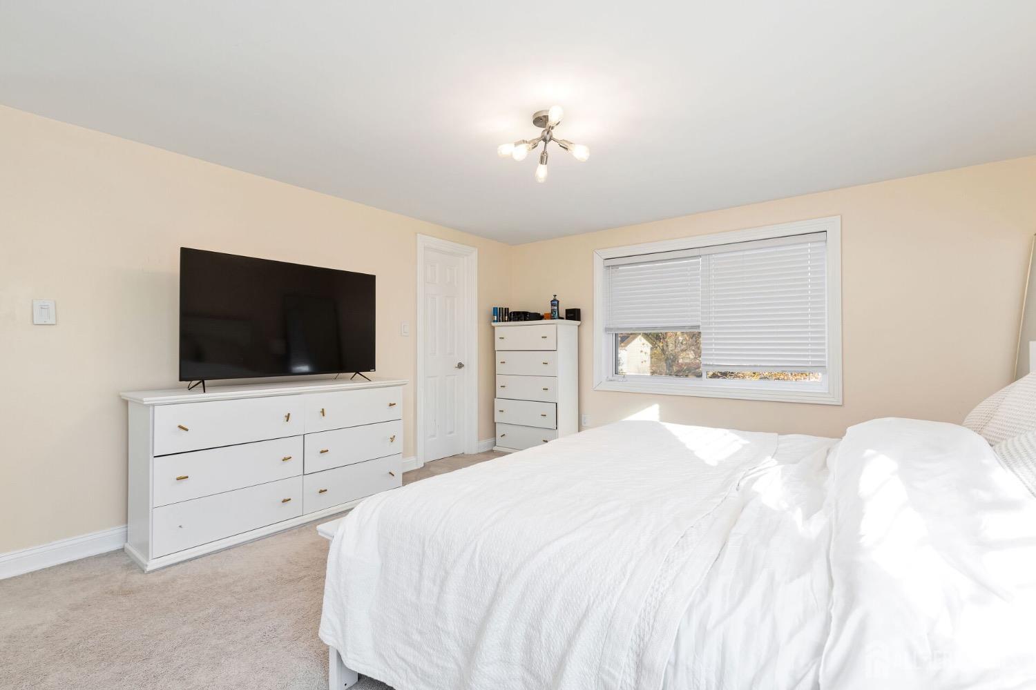 4 Indiana Road Somerset, NJ 08873 - Photo 20 of 31 a bedroom with a bed a flat screen tv and a dresser