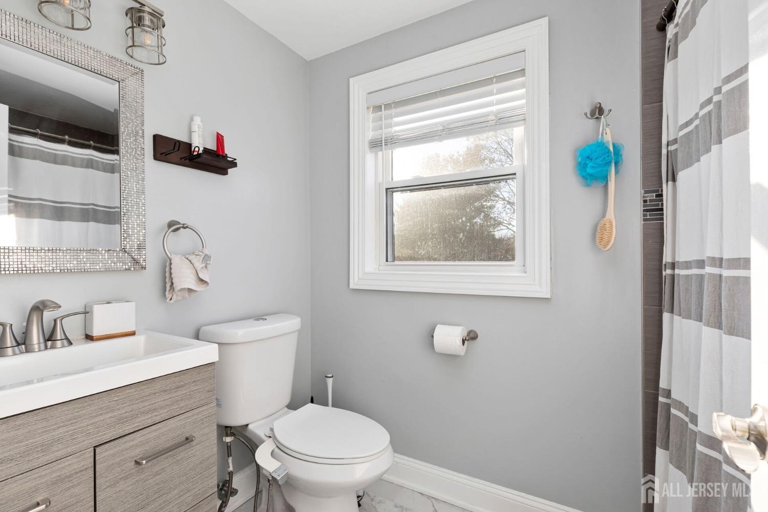 4 Indiana Road Somerset, NJ 08873 - Photo 23 of 31 a bathroom with a toilet sink and mirror