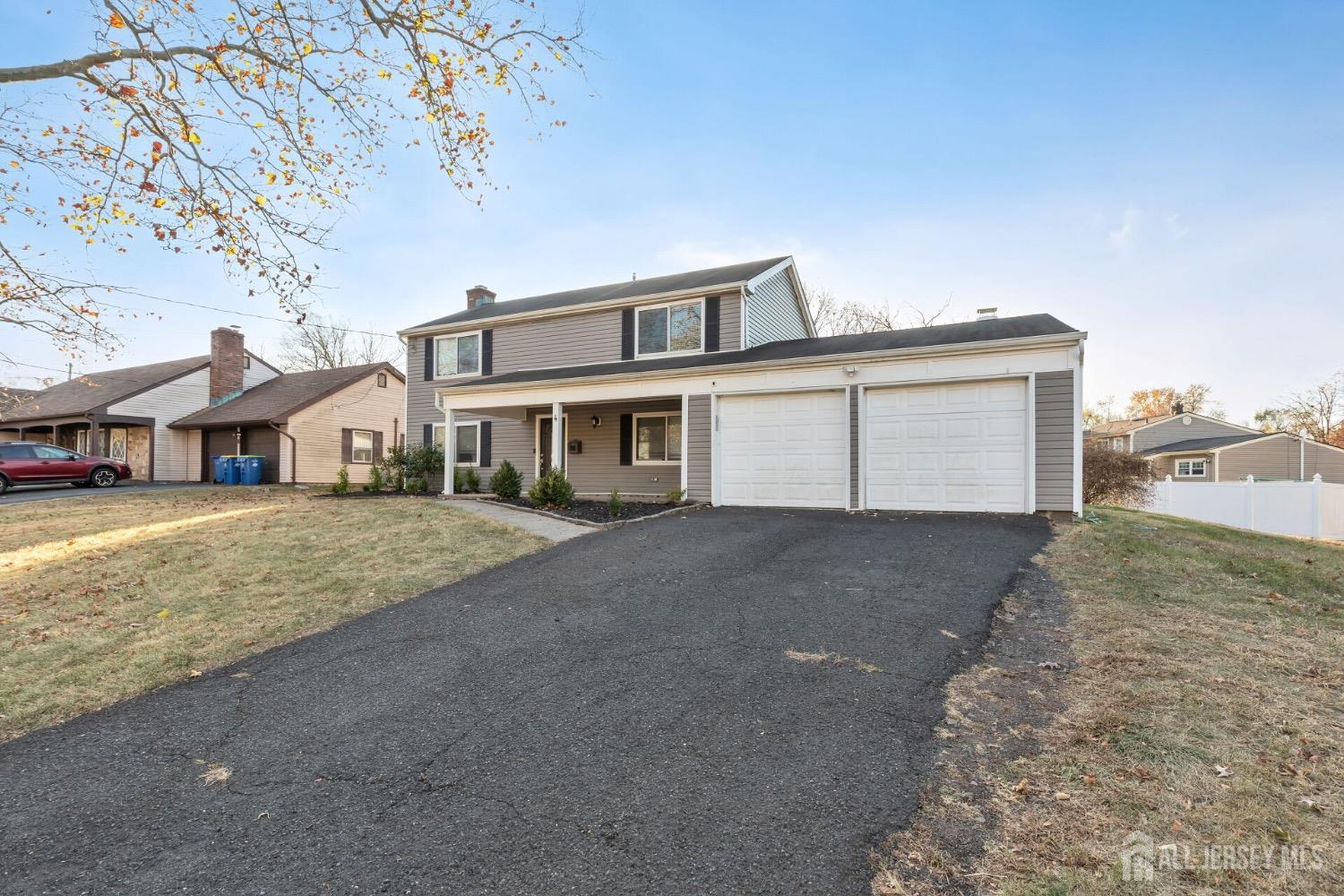 4 Indiana Road Somerset, NJ 08873 - Photo 24 of 31 a front view of a house with a yard and garage
