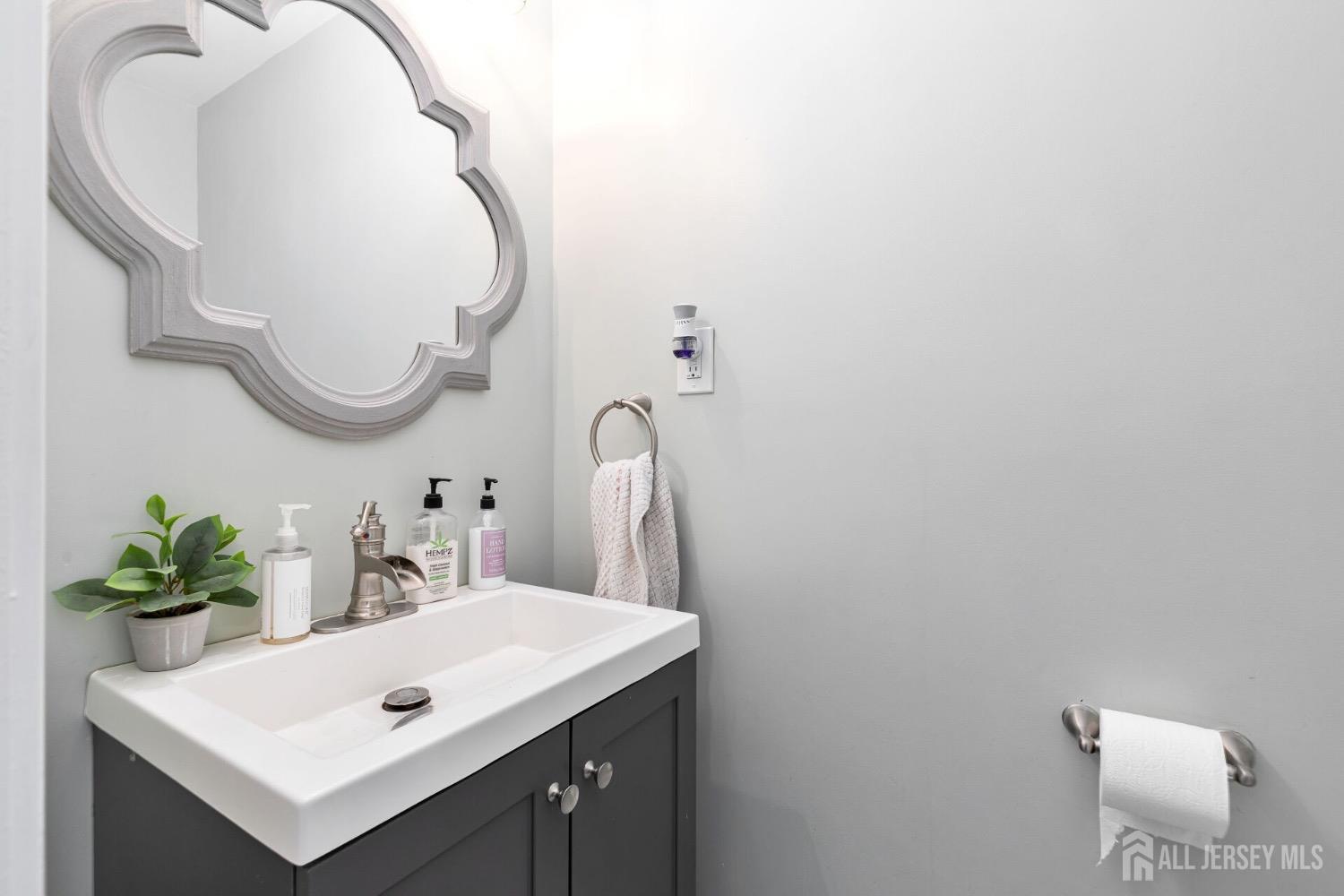 4 Indiana Road Somerset, NJ 08873 - Photo 8 of 31 a bathroom with a sink and a mirror