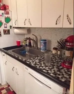 a kitchen with a stove a sink and cabinets